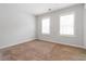 Bright bedroom features neutral carpet, light-colored walls, and plantation shutters for a cozy, inviting atmosphere at 1227 Herty Dr, Marietta, GA 30062