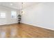 Open dining area with hardwood floors, stylish light fixture, and access to a door and window at 1227 Herty Dr, Marietta, GA 30062