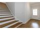 Bright foyer with hardwood floors, stairs to the second level, and a white door to the exterior at 1227 Herty Dr, Marietta, GA 30062