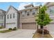 Attractive townhome showcases a two-car garage, a mix of brick and siding, and front yard landscaping at 1227 Herty Dr, Marietta, GA 30062