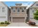 Inviting townhome with a two-car garage, brick and siding facade, and well-maintained front yard at 1227 Herty Dr, Marietta, GA 30062
