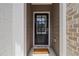 Covered front door entry with sidelights and a brick surround, creating a welcoming entrance at 1227 Herty Dr, Marietta, GA 30062