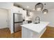 Bright, modern kitchen boasts an island, stainless steel appliances, and stylish pendant lights at 1227 Herty Dr, Marietta, GA 30062