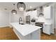 Modern kitchen island features white cabinets, stainless appliances, and quartz counters at 1227 Herty Dr, Marietta, GA 30062