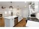 Modern open-concept kitchen boasts stainless appliances, stylish lighting, and spacious layout at 1227 Herty Dr, Marietta, GA 30062