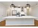 Modern kitchen features a large quartz countertop island, stainless steel appliances, and pendant lighting at 1227 Herty Dr, Marietta, GA 30062