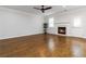 Bright living room showcasing hardwood floors, fireplace, ceiling fan, and ample space for furniture at 1227 Herty Dr, Marietta, GA 30062