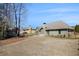 Spacious backyard with lawn and view of rear exterior of the home and storage shed at 448 Hanover Drive, Villa Rica, GA 30180
