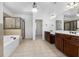 Elegant bathroom featuring a soaking tub, tiled shower, and double vanities at 448 Hanover Drive, Villa Rica, GA 30180