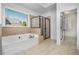 Bright bathroom with a large soaking tub and a glass-enclosed shower at 448 Hanover Drive, Villa Rica, GA 30180