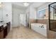 Well-lit bathroom with soaking tub, shower, and dark wood vanity at 448 Hanover Drive, Villa Rica, GA 30180