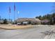 Community center with flagpole and parking lot, set against a backdrop of mature trees at 448 Hanover Drive, Villa Rica, GA 30180