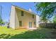 A spacious backyard featuring lush green grass, mature trees, and a small patio at 4812 Browns Mill Ferry Rd, Lithonia, GA 30038