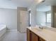 Bathroom featuring a large vanity with a sink and a separate tub with tile floors at 4812 Browns Mill Ferry Rd, Lithonia, GA 30038