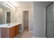 Bathroom featuring a vanity with a sink, walk-in closet and a glass door shower at 4812 Browns Mill Ferry Rd, Lithonia, GA 30038