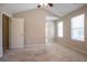 Vaulted ceiling bedroom with two windows, plush carpet, and neutral paint at 4812 Browns Mill Ferry Rd, Lithonia, GA 30038