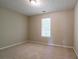 Neutral bedroom with plush carpet and a window for natural light at 4812 Browns Mill Ferry Rd, Lithonia, GA 30038