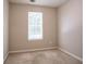 Neutral bedroom featuring carpet floors, a window offering natural light, and freshly painted walls at 4812 Browns Mill Ferry Rd, Lithonia, GA 30038