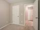 Cozy carpeted bedroom featuring two white doors and neutral paint, offering a serene and inviting space at 4812 Browns Mill Ferry Rd, Lithonia, GA 30038