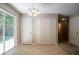 Dining area with neutral walls, tile flooring, sliding glass doors to the backyard and multiple closets at 4812 Browns Mill Ferry Rd, Lithonia, GA 30038