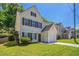 Charming two-story home with light yellow siding, brown shutters, a well-kept lawn, and an attached one car garage at 4812 Browns Mill Ferry Rd, Lithonia, GA 30038