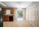 Kitchen area features wood cabinets, black appliances, tile flooring, and sliding glass doors to the backyard at 4812 Browns Mill Ferry Rd, Lithonia, GA 30038