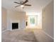 Living room featuring neutral walls and carpet, a fireplace, and access to kitchen and dining areas at 4812 Browns Mill Ferry Rd, Lithonia, GA 30038