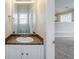 Well-lit half bathroom with a mirror, vanity, and view of the next room at 4889 Hidden Creek Pl, Decatur, GA 30035