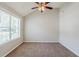 Cozy bedroom with neutral carpet, ceiling fan, and ample natural light at 4889 Hidden Creek Pl, Decatur, GA 30035