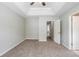 Spacious carpeted bedroom with bright neutral walls and adjacent door at 4889 Hidden Creek Pl, Decatur, GA 30035