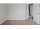 Minimalist bedroom features a neutral carpet and an entrance into the next room with multiple storage options at 4889 Hidden Creek Pl, Decatur, GA 30035