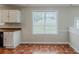 Bright kitchen with white cabinets and tile flooring and natural light at 4889 Hidden Creek Pl, Decatur, GA 30035