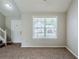 Bright living room with neutral walls and carpet, featuring a large window at 4889 Hidden Creek Pl, Decatur, GA 30035