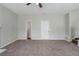 Neutral living room with plush carpet, ceiling fan, and an open doorway to adjacent rooms at 4889 Hidden Creek Pl, Decatur, GA 30035