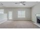 Open concept living room with lots of light, with a fireplace and access to outdoor space at 4889 Hidden Creek Pl, Decatur, GA 30035
