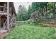 Beautiful backyard with mature trees, a wooden fence, and terraced landscaping at 1425 Turtle Dove Ln, Lawrenceville, GA 30043