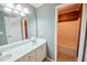 This bathroom features tile floors, a double sink vanity, and a tub/shower combo at 1425 Turtle Dove Ln, Lawrenceville, GA 30043