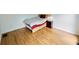 Bedroom with hardwood floors, a bed, a nightstand, and a lamp at 1425 Turtle Dove Ln, Lawrenceville, GA 30043