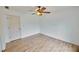 This bedroom features wood laminate flooring, neutral paint, and a ceiling fan at 1425 Turtle Dove Ln, Lawrenceville, GA 30043
