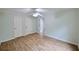 Bedroom with wood laminate flooring, neutral paint, and two doors at 1425 Turtle Dove Ln, Lawrenceville, GA 30043