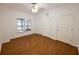 Bright bedroom with hardwood floors, a large window, and two closets for ample storage space at 1425 Turtle Dove Ln, Lawrenceville, GA 30043