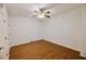 Simple bedroom with hardwood floors, a ceiling fan, and white walls at 1425 Turtle Dove Ln, Lawrenceville, GA 30043