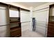 A walk-in closet with wood shelving and hanging rods provides ample storage at 1425 Turtle Dove Ln, Lawrenceville, GA 30043