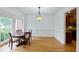 Dining room with hardwood floors, a round wooden table, and wainscoting at 1425 Turtle Dove Ln, Lawrenceville, GA 30043