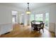 Bright dining room with hardwood floors, a round wooden table, and a bay window at 1425 Turtle Dove Ln, Lawrenceville, GA 30043