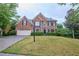 Beautiful two-story brick home with a well-manicured lawn and attached two-car garage at 1425 Turtle Dove Ln, Lawrenceville, GA 30043