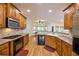 Kitchen with wood cabinets, granite countertops, and stainless steel appliances at 1425 Turtle Dove Ln, Lawrenceville, GA 30043