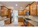 Kitchen with wood cabinets, granite countertops, and stainless steel appliances at 1425 Turtle Dove Ln, Lawrenceville, GA 30043