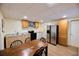 Functional kitchen with wood cabinets, stainless steel fridge, and adjacent dining area at 1425 Turtle Dove Ln, Lawrenceville, GA 30043