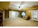 Spacious living room with neutral carpet, ceiling fan, and comfortable seating at 1425 Turtle Dove Ln, Lawrenceville, GA 30043
